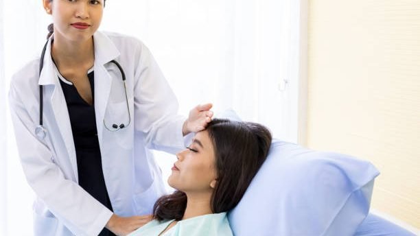 Asian Doctor make routine health check with patient in hospital ward