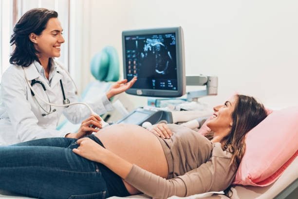 Female doctor and a pregnant woman during ultrasound exam in the hospital